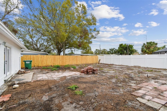 view of yard with a fenced backyard and a patio