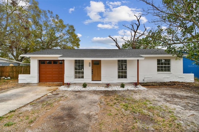 single story home featuring stucco siding, concrete driveway, covered porch, fence, and a garage