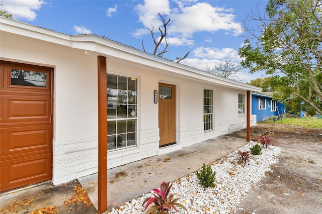 view of exterior entry featuring a garage