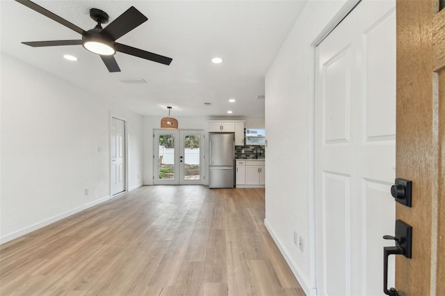 unfurnished living room with ceiling fan, recessed lighting, baseboards, light wood-style floors, and french doors