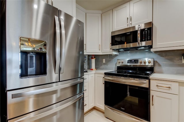 kitchen featuring light countertops, white cabinets, tasteful backsplash, and appliances with stainless steel finishes