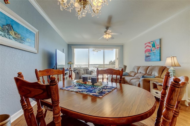 dining room featuring ornamental molding, ceiling fan with notable chandelier, and wood finished floors