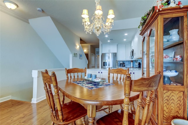 dining room featuring recessed lighting, baseboards, light wood finished floors, and a chandelier