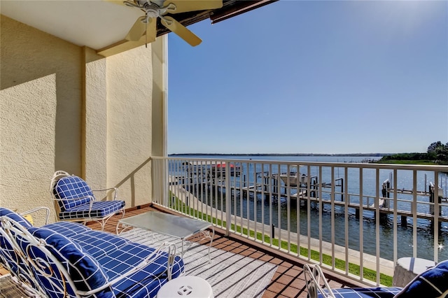 balcony featuring a water view and ceiling fan