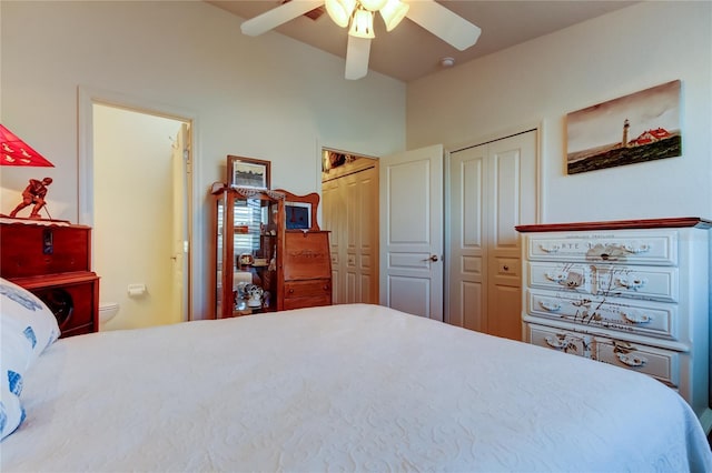 bedroom featuring ensuite bathroom, a ceiling fan, and two closets