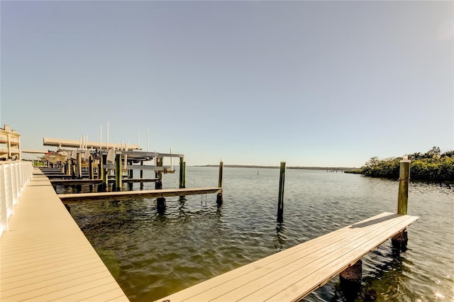 view of dock with boat lift and a water view