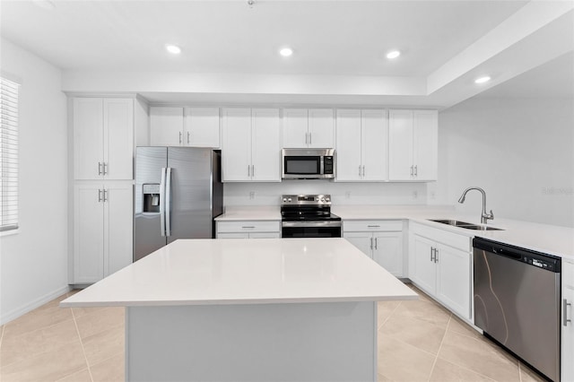 kitchen with light tile patterned floors, stainless steel appliances, light countertops, and a sink