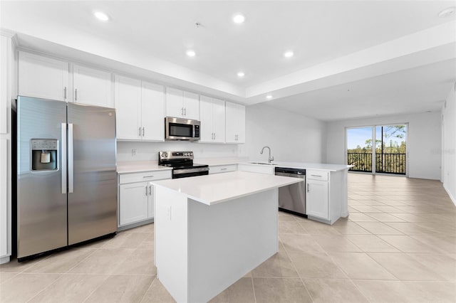 kitchen featuring light countertops, light tile patterned floors, recessed lighting, appliances with stainless steel finishes, and a peninsula