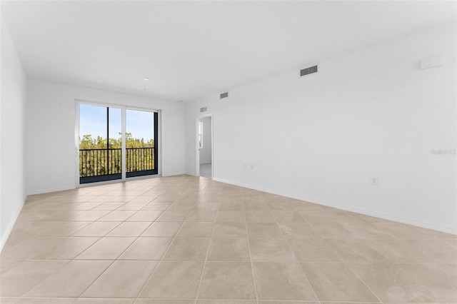 unfurnished room featuring light tile patterned floors, baseboards, and visible vents