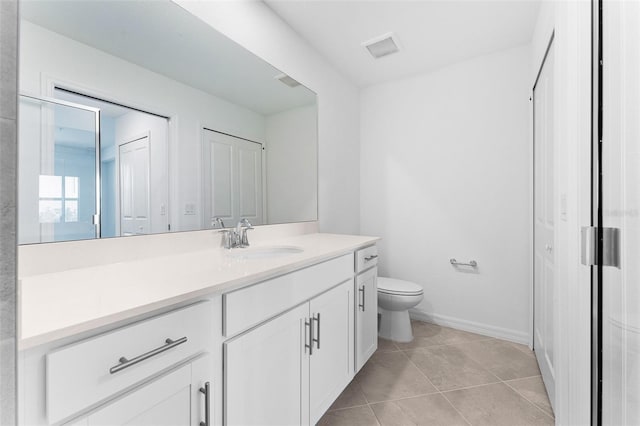 bathroom with visible vents, toilet, tile patterned flooring, baseboards, and vanity