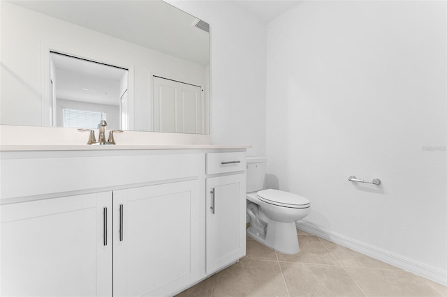 bathroom featuring vanity, visible vents, baseboards, tile patterned flooring, and toilet