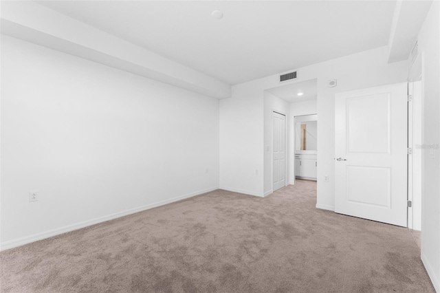 unfurnished room featuring visible vents, baseboards, and carpet floors