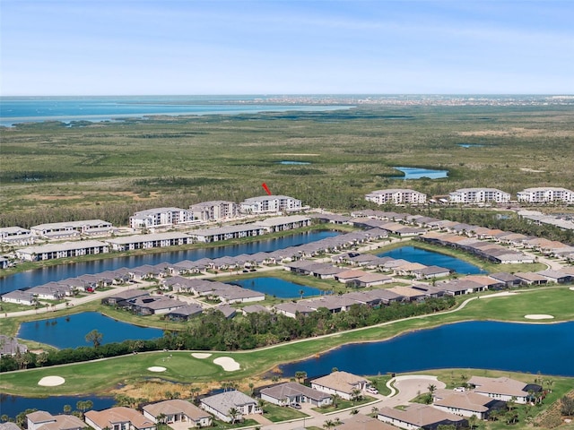 aerial view with a residential view, golf course view, and a water view