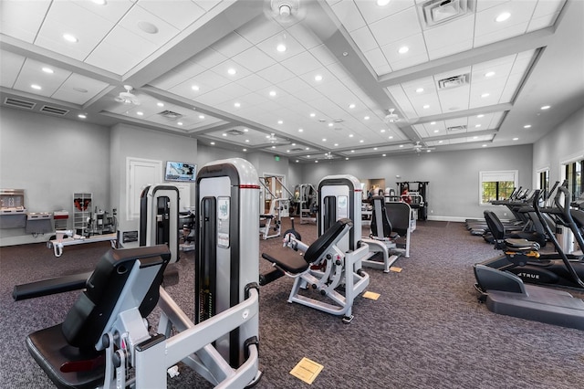 gym with visible vents, arched walkways, and baseboards