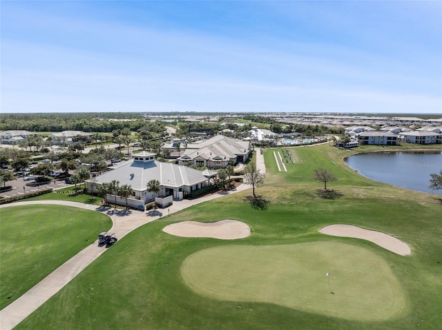 bird's eye view featuring a water view and view of golf course