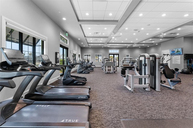 exercise room featuring recessed lighting and a towering ceiling