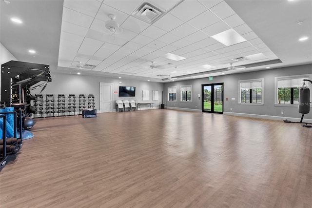 workout area featuring a wealth of natural light, visible vents, a ceiling fan, and wood finished floors