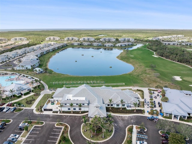 birds eye view of property with view of golf course, a water view, and a residential view