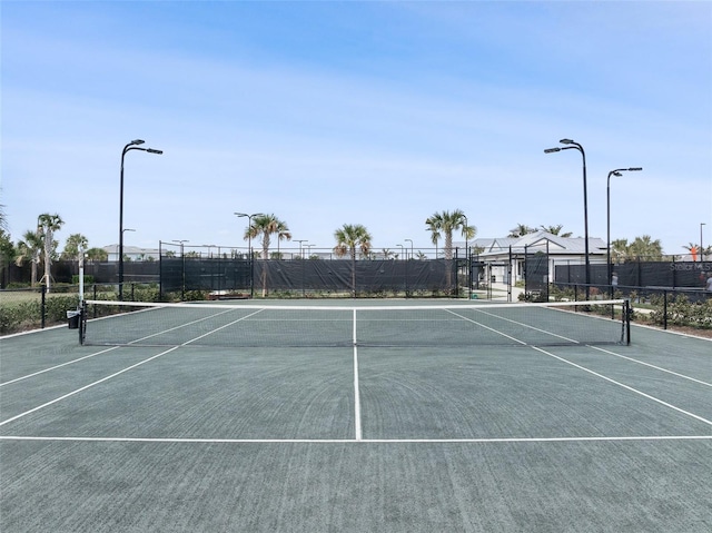 view of tennis court with fence