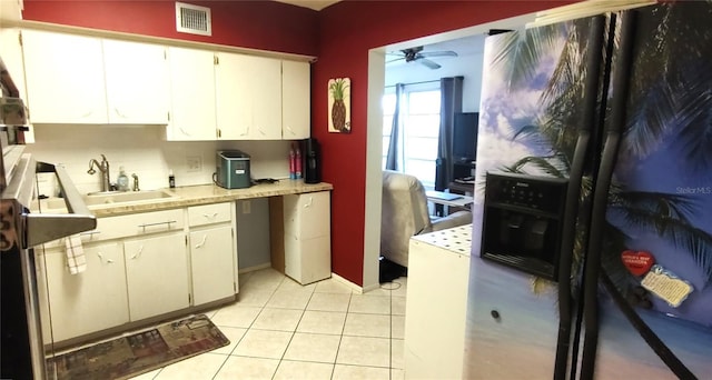 kitchen featuring light tile patterned floors, a sink, visible vents, a ceiling fan, and light countertops