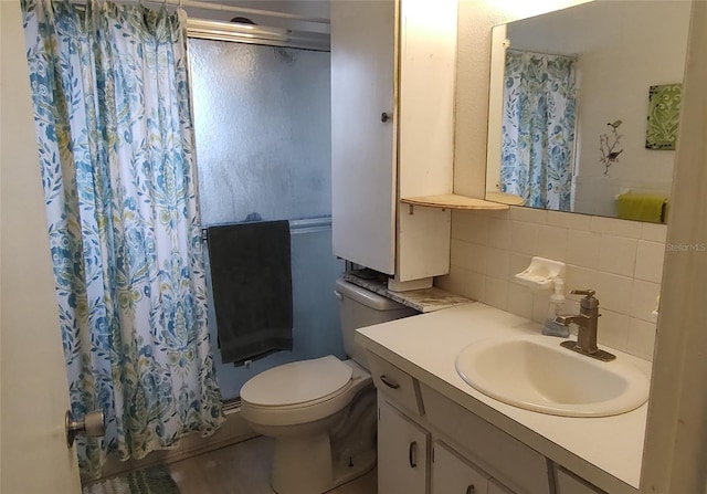 full bathroom featuring toilet, decorative backsplash, and vanity