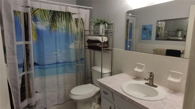 bathroom featuring toilet, vanity, tile walls, and a shower with shower curtain