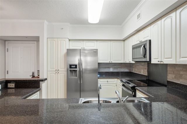 kitchen featuring a sink, white cabinetry, stainless steel appliances, and crown molding