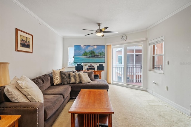 living area featuring light colored carpet, crown molding, baseboards, and ceiling fan