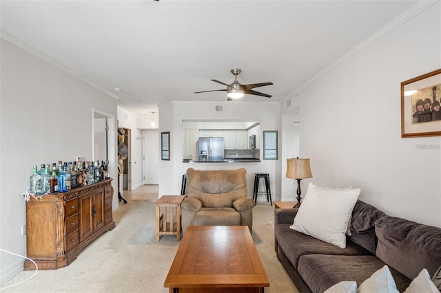 living area featuring baseboards, a ceiling fan, crown molding, and light colored carpet