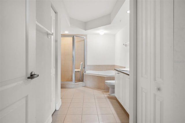 bathroom featuring toilet, tile patterned floors, vanity, a shower stall, and a closet