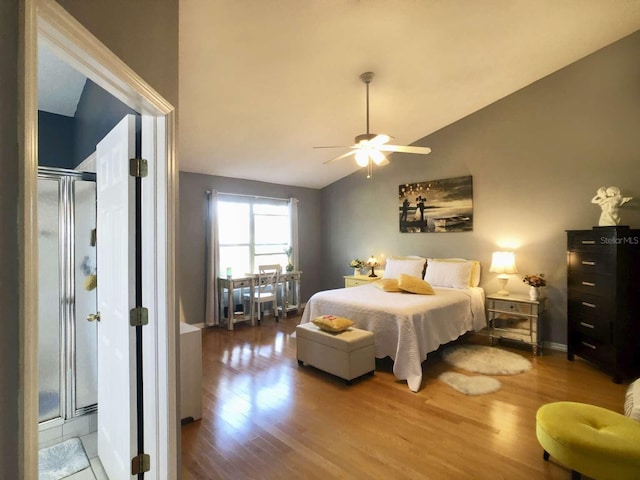 bedroom featuring a ceiling fan, lofted ceiling, baseboards, and wood finished floors