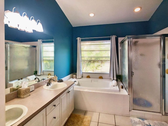 full bathroom featuring tile patterned flooring, a sink, a healthy amount of sunlight, a bath, and double vanity