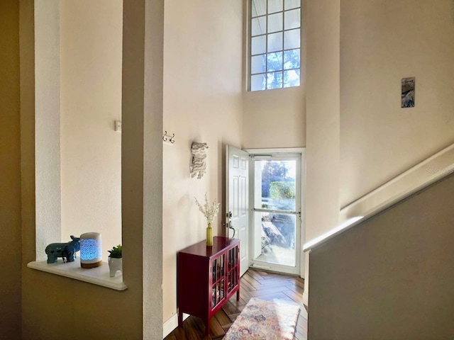 foyer featuring a towering ceiling