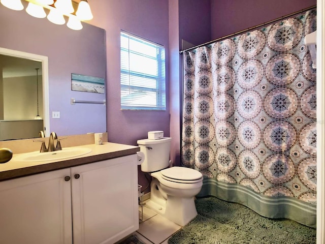 bathroom featuring toilet, vanity, and a notable chandelier