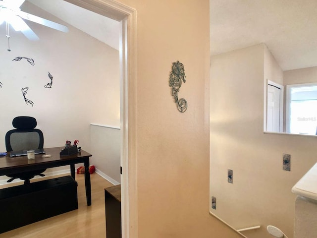 bathroom with ceiling fan, baseboards, and wood finished floors