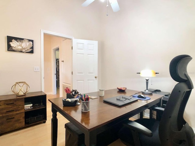 home office featuring light wood-style flooring and a ceiling fan