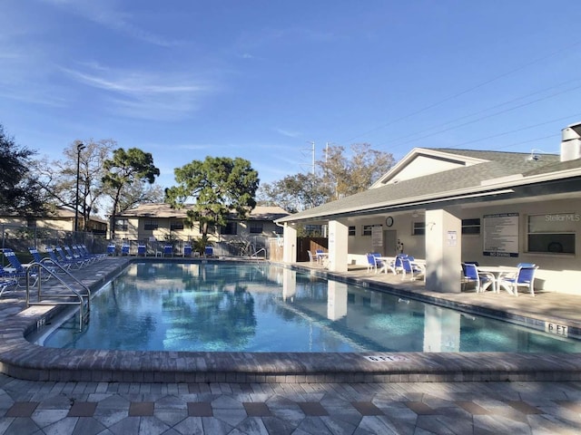 pool featuring a patio area and fence