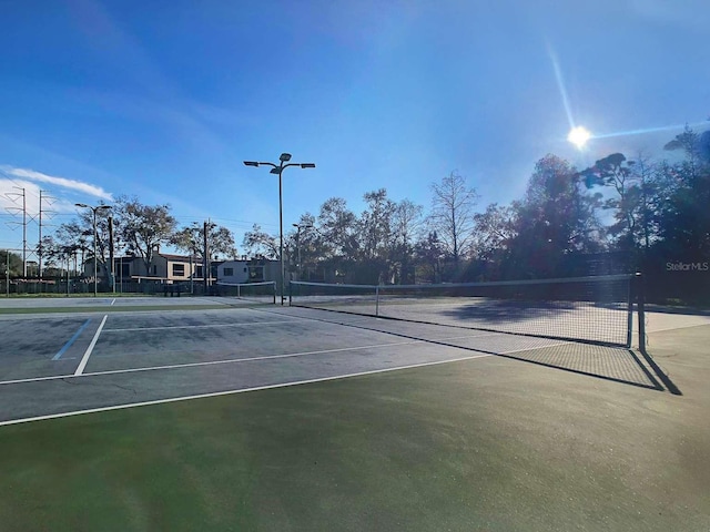 view of tennis court with fence