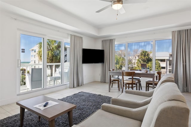 tiled living room with baseboards and a ceiling fan