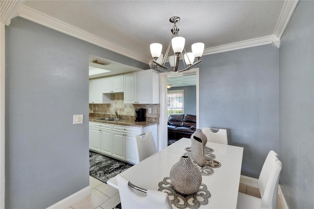 dining room featuring light tile patterned floors, visible vents, baseboards, crown molding, and a notable chandelier