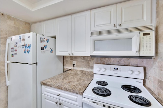 kitchen featuring tasteful backsplash, white appliances, and white cabinets