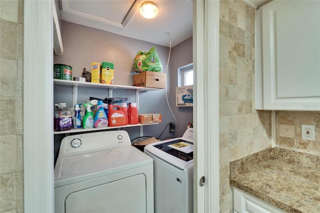 laundry area with laundry area, tile walls, and washing machine and clothes dryer