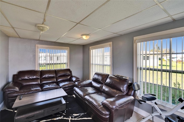 living room with a wealth of natural light and a paneled ceiling