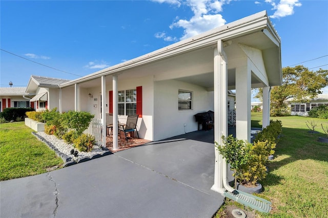 view of front of property featuring a front yard and stucco siding