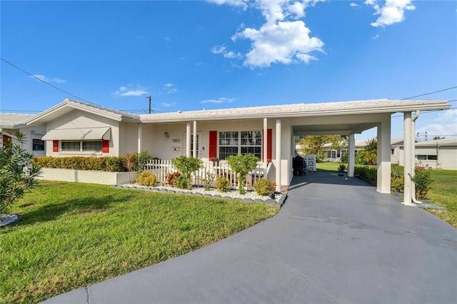 single story home featuring a front yard, driveway, an attached carport, and stucco siding