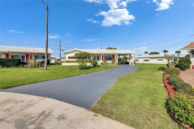 ranch-style house with a front yard and driveway