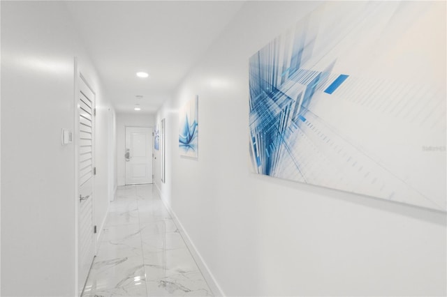 corridor featuring marble finish floor, baseboards, and recessed lighting