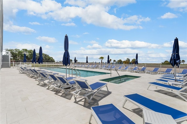 pool featuring fence, a community hot tub, and a patio