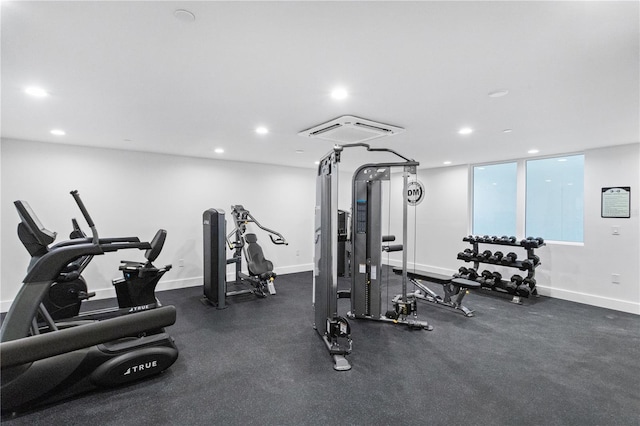 workout area featuring baseboards and recessed lighting