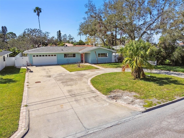ranch-style home featuring fence, an attached garage, driveway, a gate, and a front yard